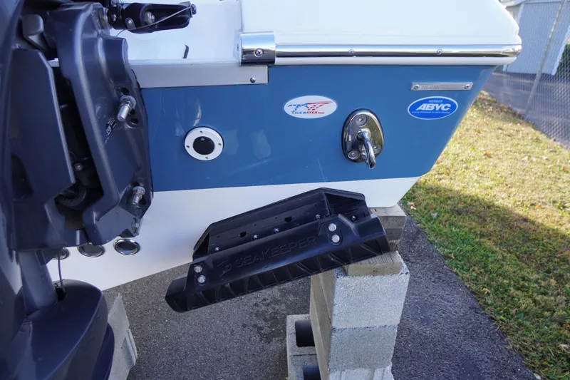 Slide: The Image of 2026 Tidewater 256 CC Adventure boat with Yamaha engine, rear view, outdoor setting. - 74