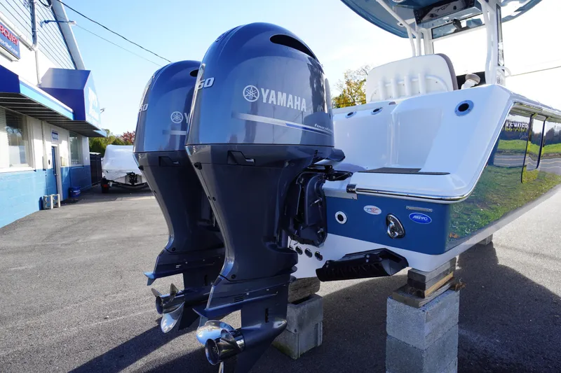 Slide: The Image of 2026 Tidewater 256 CC Adventure boat stern view with motor and deck details. - 76