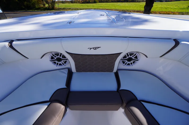 Slide: The Image of 2026 Tidewater 256 CC Adventure boat interior with cushioned seating and speakers. - 8