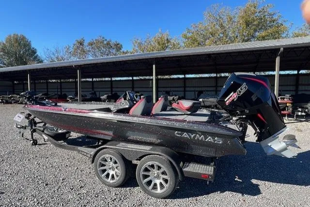 Slide: The Image of 2026 Caymas CX 20 PRO bass boat on trailer, parked outdoors under clear blue sky. - 8