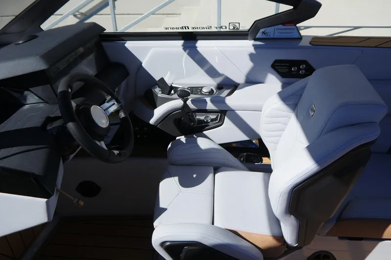 Slide: The Image of 2026 Nautique Super Air Nautique G23 cockpit with modern steering and luxurious seating. - 25