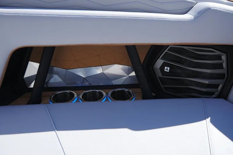 Slide: The Image of 2026 Nautique Super Air Nautique G23 interior with cup holders and speaker detail. - 29