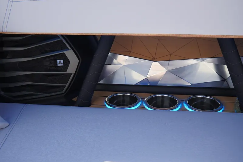 Slide: The Image of 2026 Nautique Super Air Nautique G23 interior with illuminated cup holders and modern design. - 31