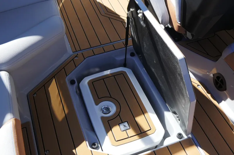 Slide: The Image of 2026 Nautique Super Air Nautique G23 interior storage compartment with teak flooring. - 33