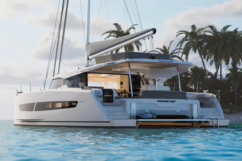 Slide: The Image of 2026 Fountaine Pajot 48 catamaran sailing near tropical island with palm trees. - 36