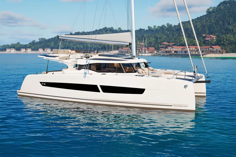 Slide: The Image of 2026 Fountaine Pajot 48 catamaran sailing in tropical waters near a coastal resort. - 42