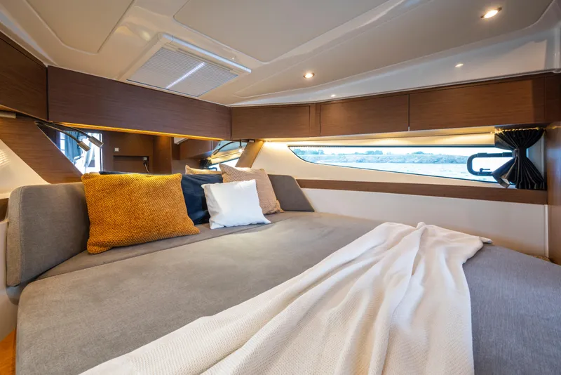 Slide: The Image of Luxurious cabin interior of 2025 Beneteau Antares 11 Fly with cozy bedding and cushions. - 16