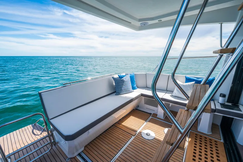 Slide: The Image of 2025 Beneteau Antares 11 Fly yacht deck with ocean view and comfortable seating. - 19