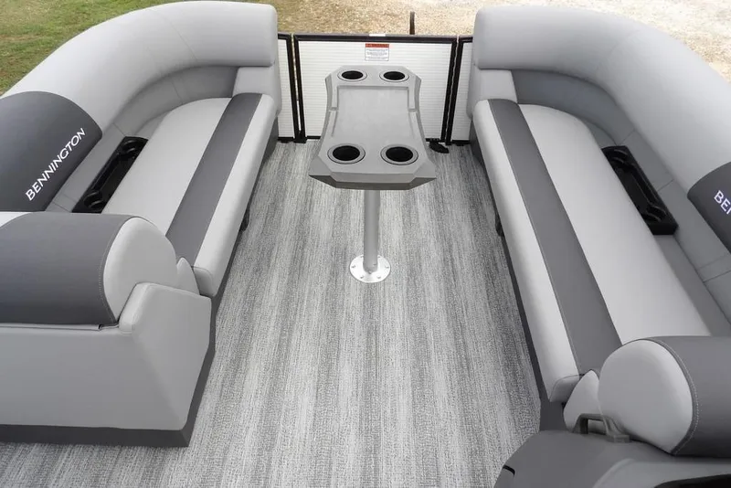 Slide: The Image of 2026 Bennington S Swingback 22 SSB interior with gray seating and central table. - 12
