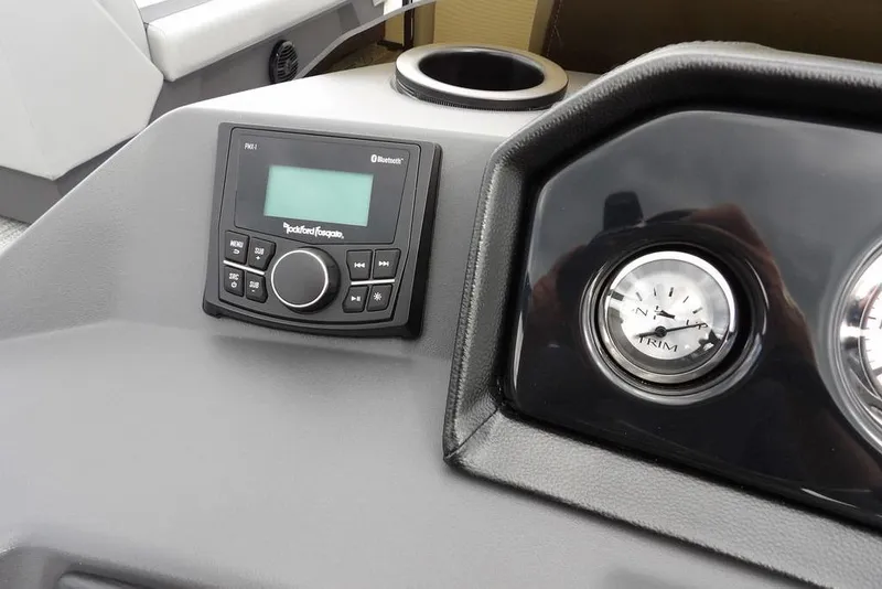 Slide: The Image of 2026 Bennington S Swingback 22 SSB dashboard with Rockford Fosgate audio system and trim gauge. - 17