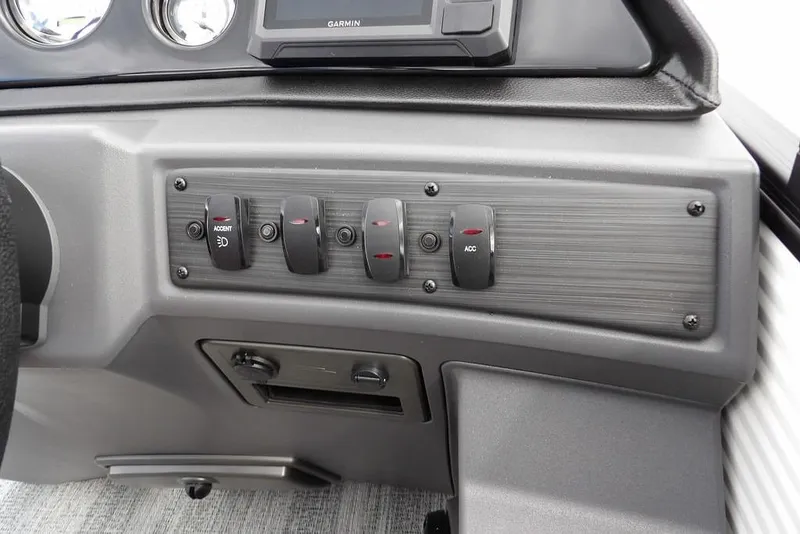 Slide: The Image of Dashboard controls of 2026 Bennington S Swingback 22 SSB boat with switches and Garmin display. - 22