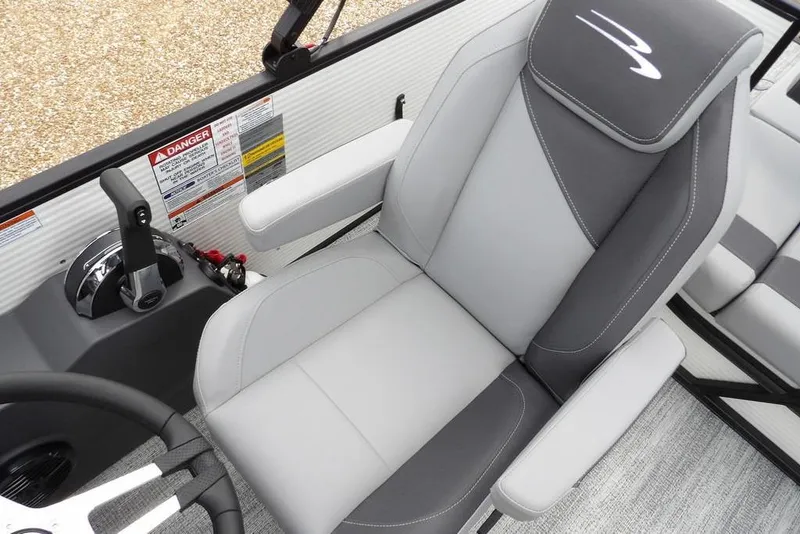 Slide: The Image of 2026 Bennington S Swingback 22 SSB boat interior with gray captain's chair and control panel. - 25