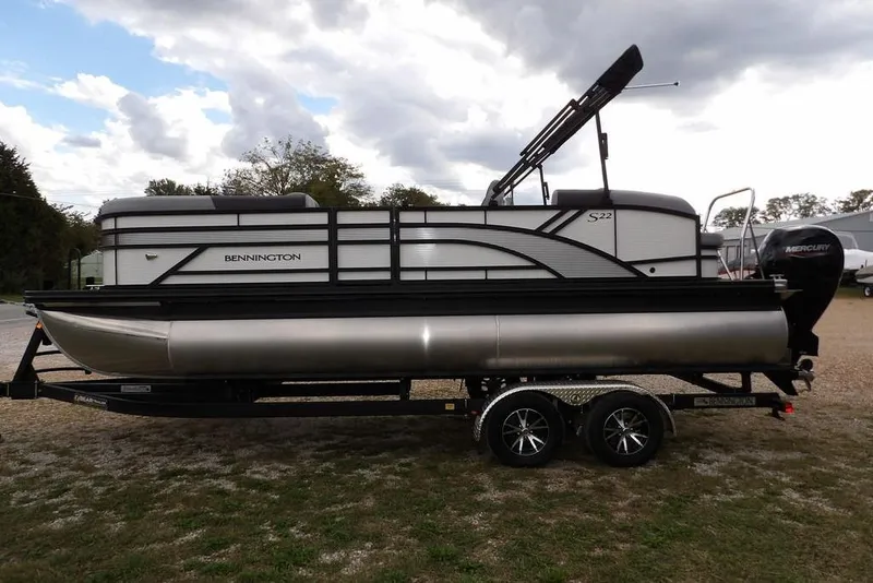 Slide: The Image of 2026 Bennington S Swingback 22 SSB pontoon boat on trailer, outdoor setting. - 5