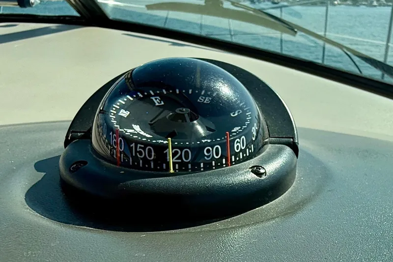 Slide: The Image of Compass on 2008 Sea Ray 38 Sundancer boat dashboard, with ocean view. - 14