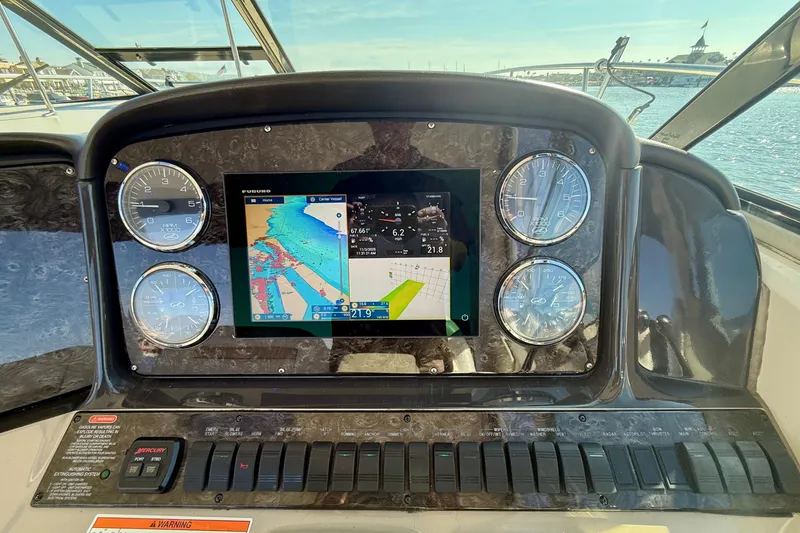 Slide: The Image of Dashboard of a 2008 Sea Ray 38 Sundancer with navigation display and gauges. - 15