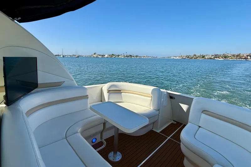 Slide: The Image of 2008 Sea Ray 38 Sundancer yacht interior with seating, table, and ocean view. - 16