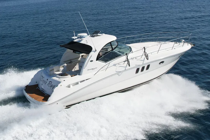 Slide: The Image of 2008 Sea Ray 38 Sundancer cruising on open water, showcasing sleek design and performance. - 2