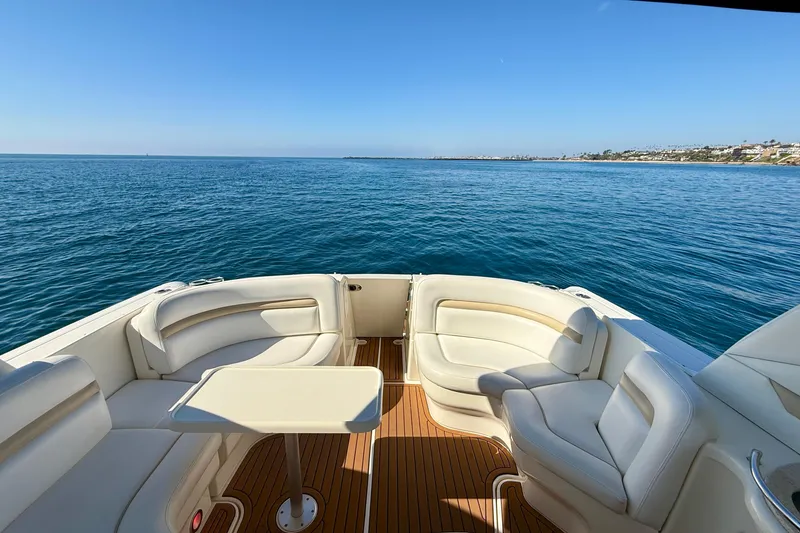 Slide: The Image of 2008 Sea Ray 38 Sundancer yacht with elegant seating, overlooking serene ocean waters. - 24