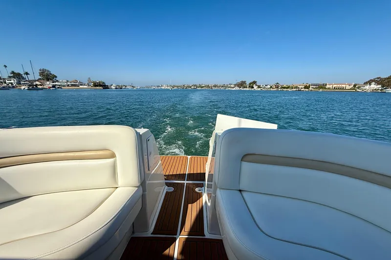 Slide: The Image of 2008 Sea Ray 38 Sundancer cruising on a sunny day, featuring luxurious seating and scenic water views. - 28