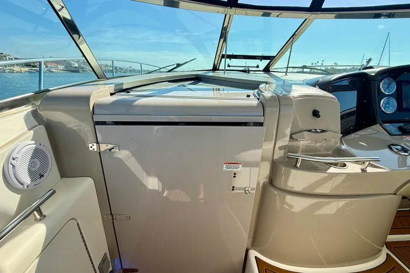 Slide: The Image of 2008 Sea Ray 38 Sundancer cockpit with helm, controls, and ocean view. - 30