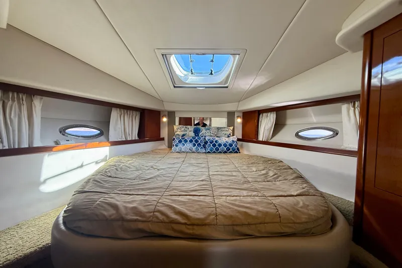 Slide: The Image of Luxurious cabin interior of 2008 Sea Ray 38 Sundancer yacht with skylight and cozy bedding. - 33