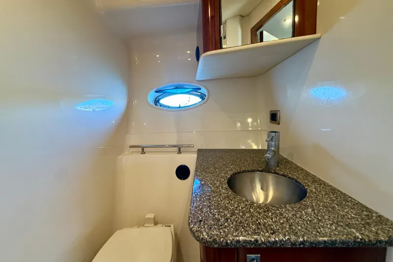 Slide: The Image of Luxurious bathroom in 2008 Sea Ray 38 Sundancer yacht with granite countertop and porthole. - 37