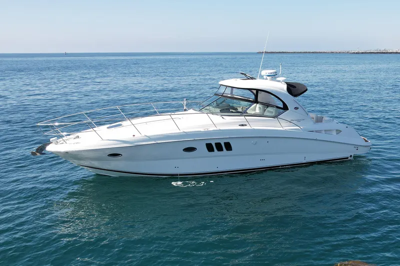 Slide: The Image of 2008 Sea Ray 38 Sundancer yacht cruising on calm blue waters. - 4