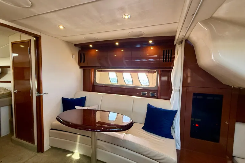 Slide: The Image of Interior of 2008 Sea Ray 38 Sundancer yacht with elegant seating and wooden finishes. - 42