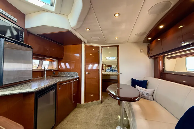 Slide: The Image of Luxurious interior of 2008 Sea Ray 38 Sundancer yacht with modern kitchen and seating area. - 43