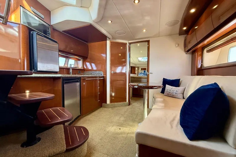 Slide: The Image of Luxurious interior of 2008 Sea Ray 38 Sundancer yacht with modern kitchen and cozy seating area. - 46