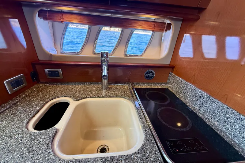 Slide: The Image of Luxurious 2008 Sea Ray 38 Sundancer yacht kitchen with sink and stovetop. - 51