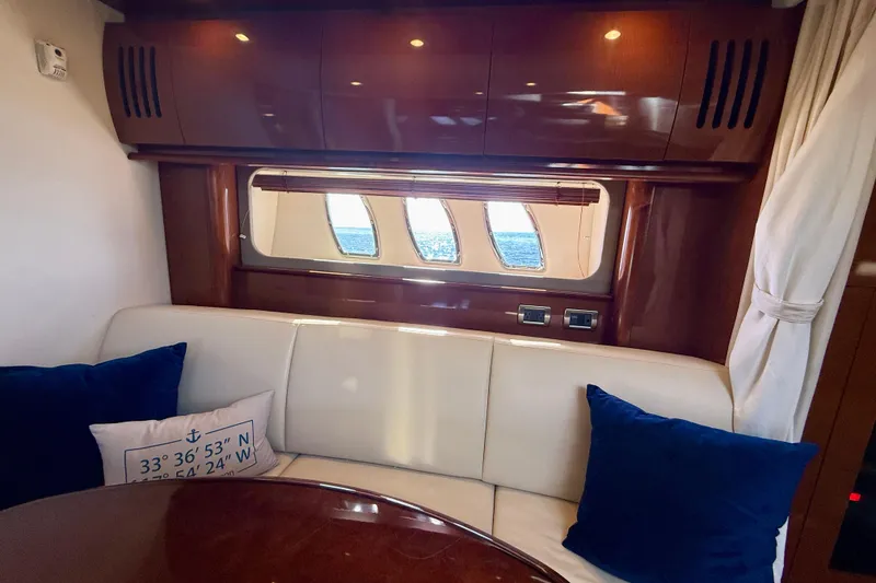 Slide: The Image of Interior of 2008 Sea Ray 38 Sundancer yacht with plush seating and ocean view. - 53