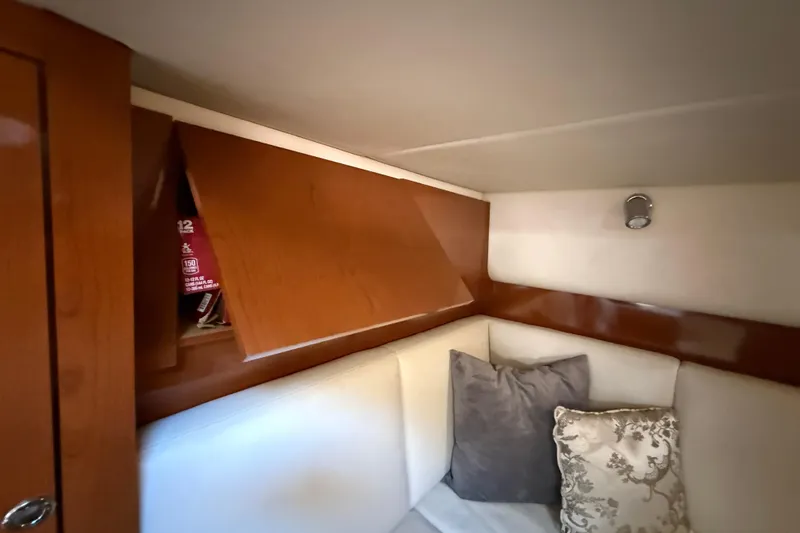 Slide: The Image of Interior of 2008 Sea Ray 38 Sundancer with wooden cabinets and cushioned seating. - 55