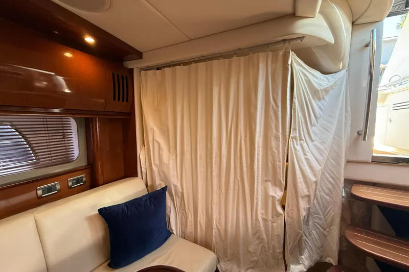 Slide: The Image of Interior of 2008 Sea Ray 38 Sundancer yacht with curtain and seating area. - 57