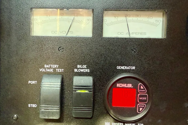 Slide: The Image of Control panel of a 2008 Sea Ray 38 Sundancer with voltage and amperage gauges. - 59
