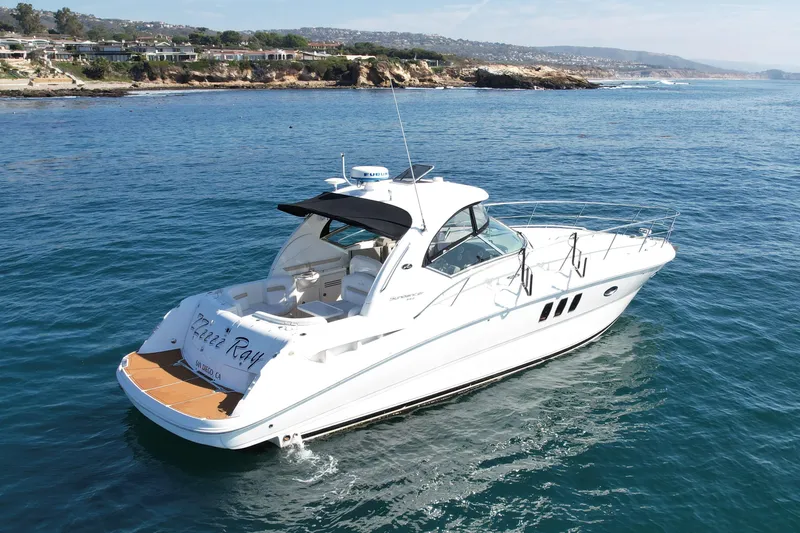 Slide: The Image of 2008 Sea Ray 38 Sundancer yacht cruising near scenic coastline. - 6