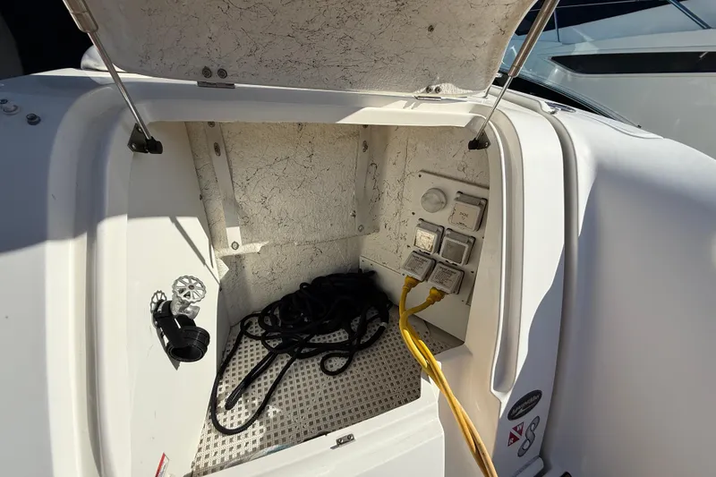 Slide: The Image of 2008 Sea Ray 38 Sundancer electrical compartment with cables and controls. - 65