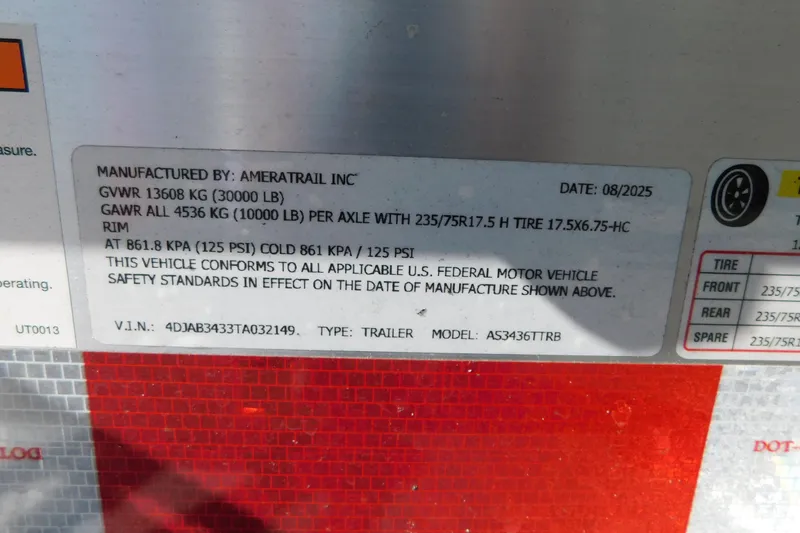 Slide: The Image of Ameratrail trailer label with specifications, including GVWR, GAWR, tire size, and VIN details. - 103