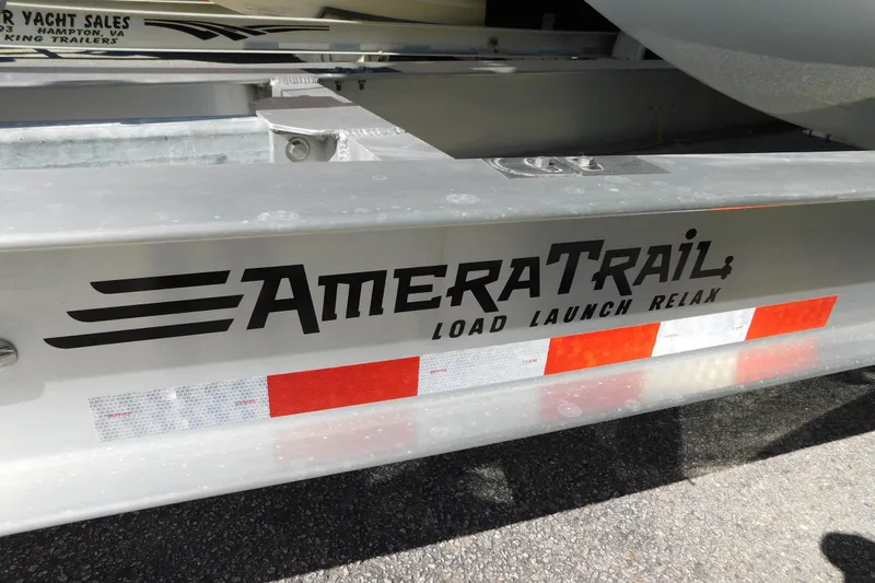 Slide: The Image of AmeraTrail boat trailer with 'Load Launch Relax' slogan, featuring reflective safety tape. - 104