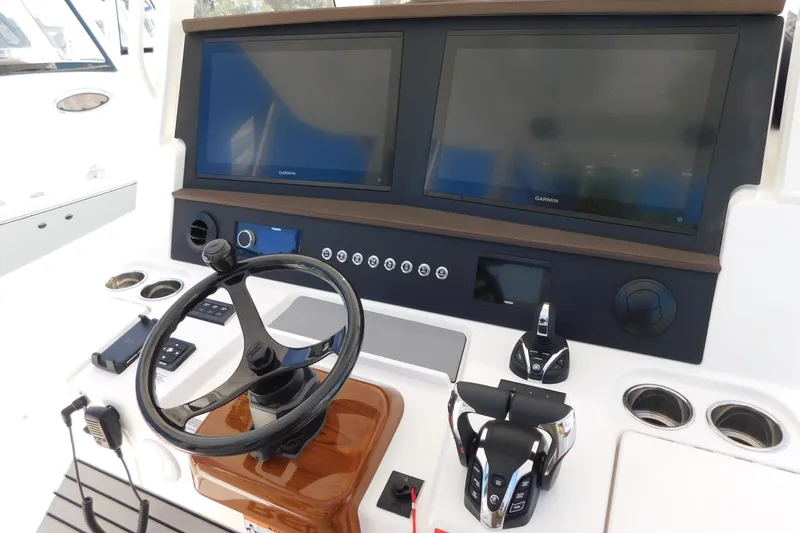 Slide: The Image of Helm of 2026 Regulator 35 boat with dual Garmin displays and modern controls. - 13
