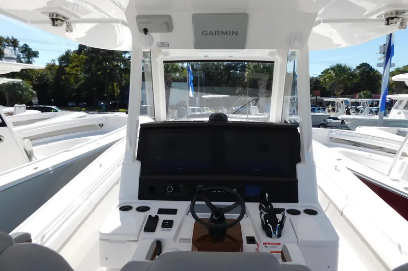 Slide: The Image of 2026 Regulator 35 boat cockpit with Garmin navigation system, steering wheel, and control panel. - 14