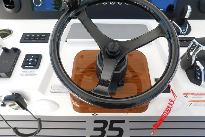 Slide: The Image of Steering wheel of 2026 Regulator 35 boat with control panel and throttle. - 16