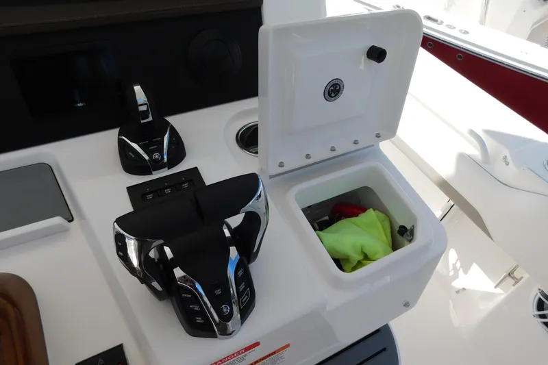 Slide: The Image of 2026 Regulator 35 boat console with controls and open storage compartment. - 17