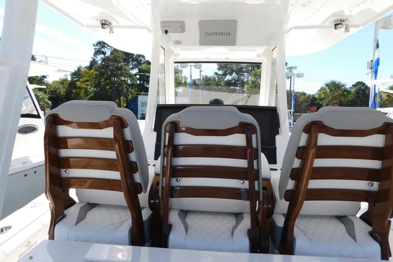 Slide: The Image of 2026 Regulator 35 boat interior with three cushioned seats and Garmin navigation system. - 20