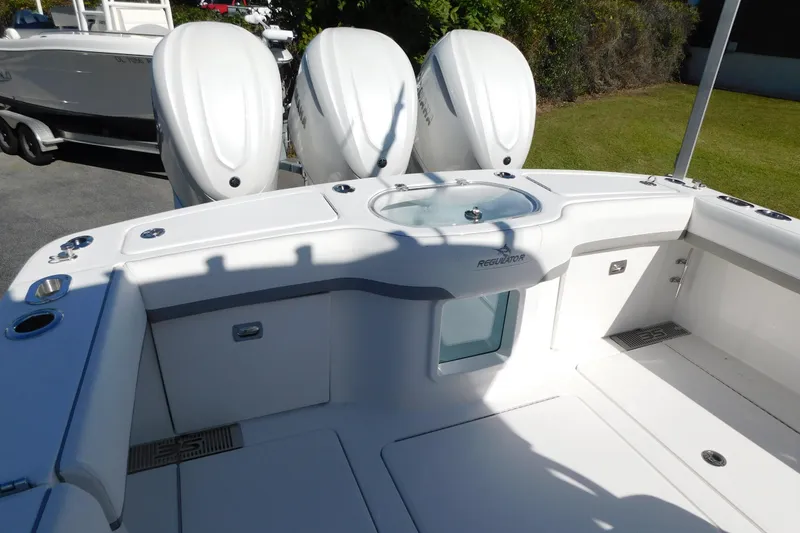 Slide: The Image of 2026 Regulator 35 boat with triple outboard engines, spacious deck, and sleek design. - 21