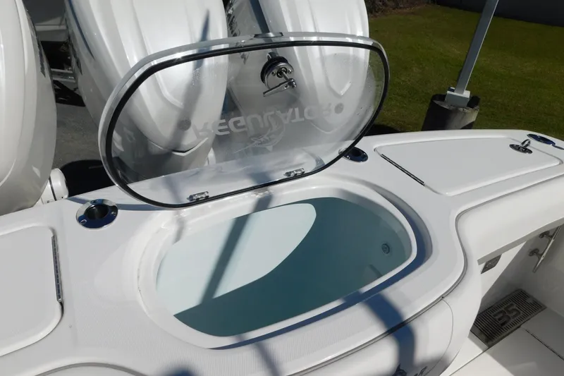 Slide: The Image of 2026 Regulator 35 boat with open livewell and triple outboard engines. - 23