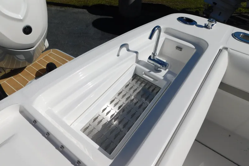 Slide: The Image of 2026 Regulator 35 boat sink and faucet detail with Yamaha engine in background. - 24