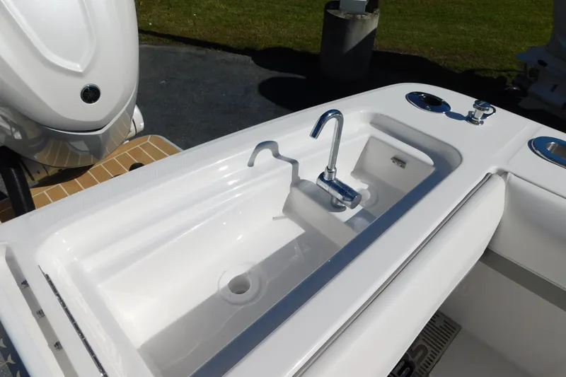 Slide: The Image of 2026 Regulator 35 boat sink and faucet detail with Yamaha engine in background. - 25