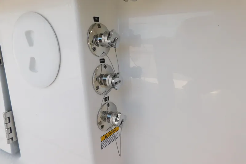 Slide: The Image of Boat fuel connectors on a 2026 Regulator 35, featuring labeled ports and safety warnings. - 31