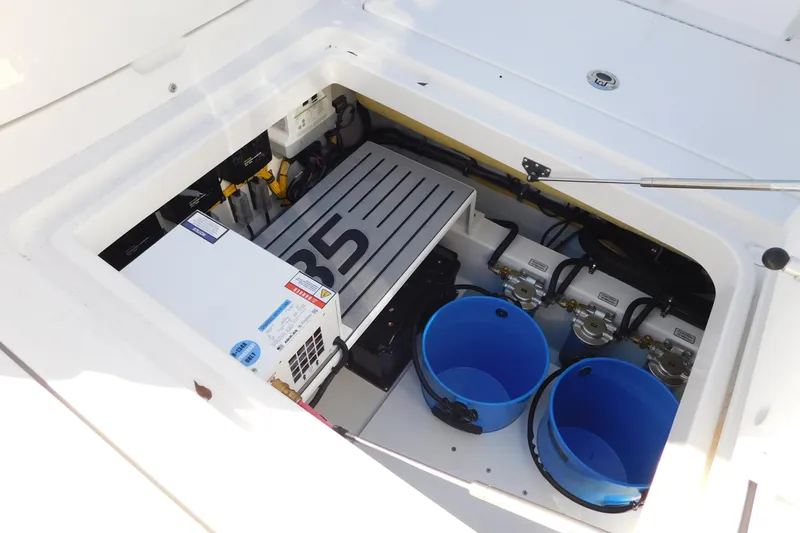Slide: The Image of 2026 Regulator 35 boat storage compartment with equipment and blue buckets. - 32